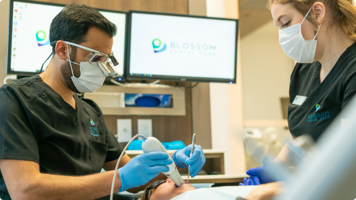Dentist and assistant providing dental treatment